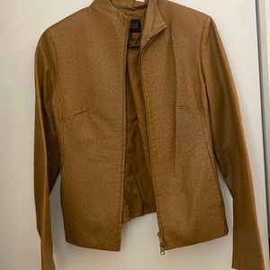 Ladies brown ostrich print leather jacket, it has a burn hole on the back.